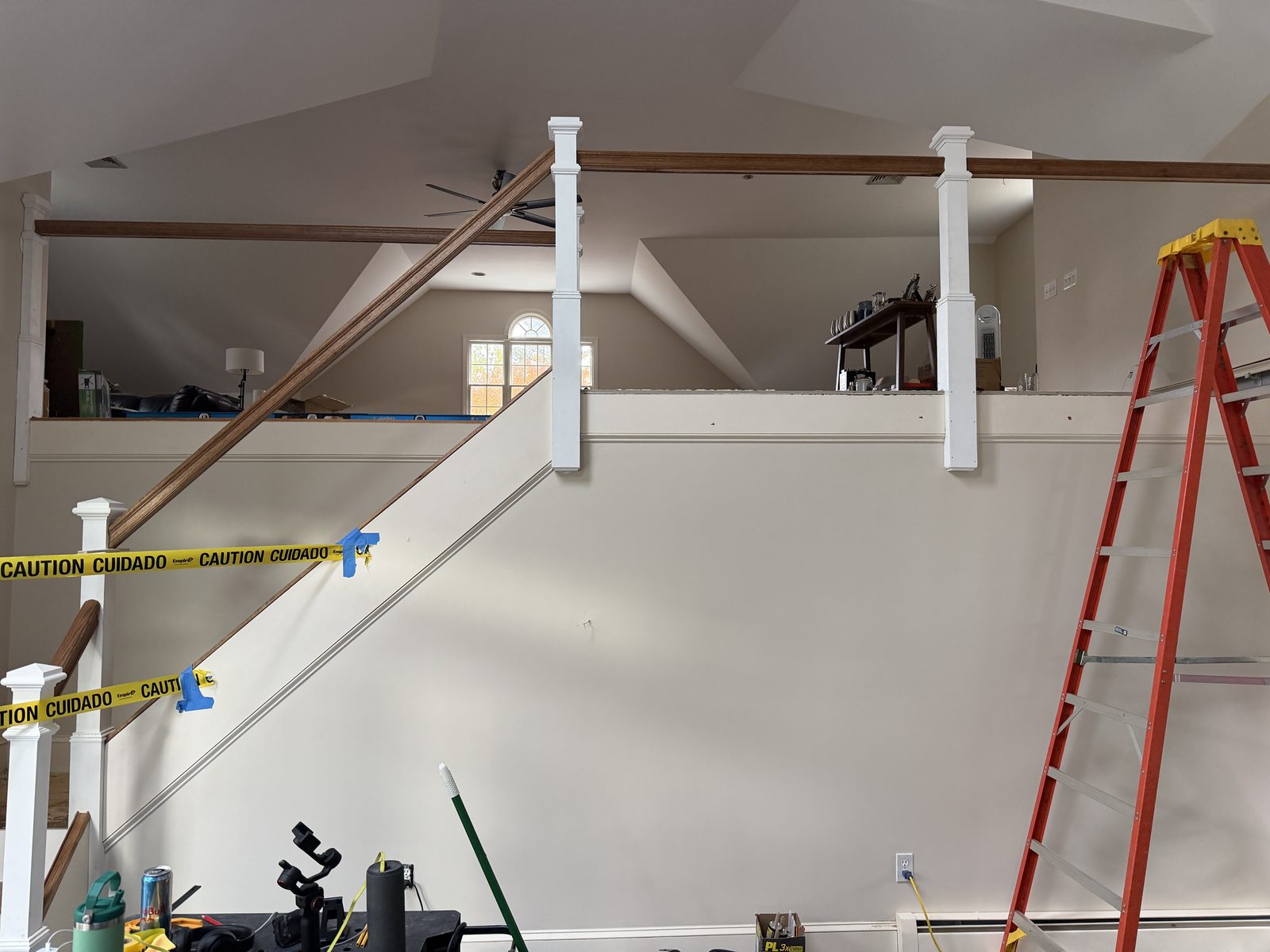 Square newel posts and handrails set along the open staircase and upper landing before balusters were fitted in Rehoboth, MA.