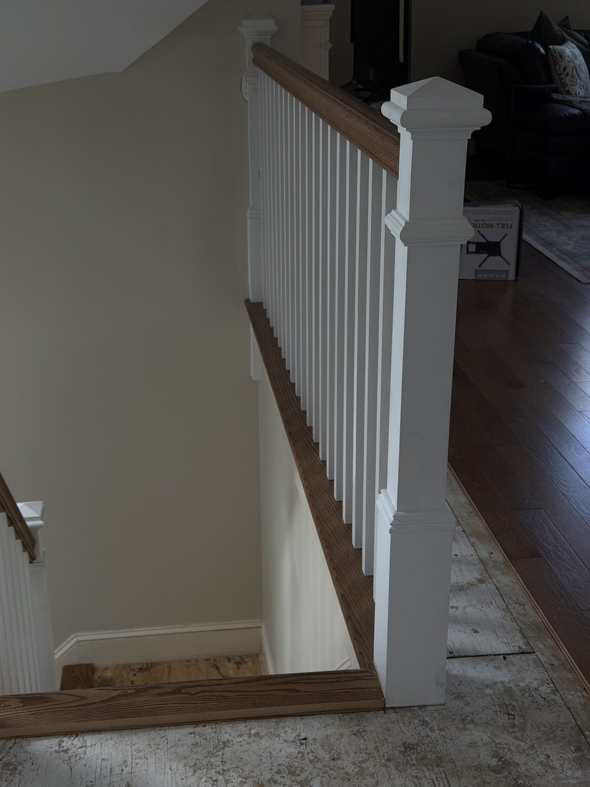 Upper railing with square white balusters, a red oak handrail and a square newel post during the Rehoboth staircase rebuild.